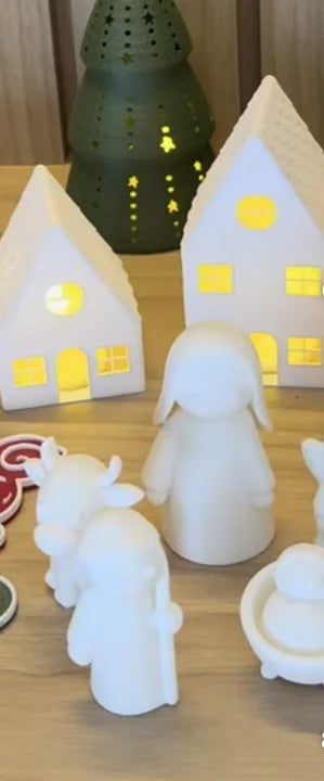 Mesa com casinhas iluminadas, árvores e presépio branco impressos em 3D